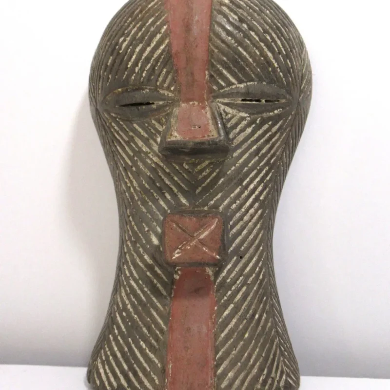 African tribal mask with linear pattern, hand-carved wooden mask